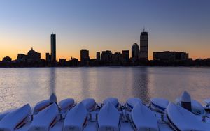 Preview wallpaper skyscrapers, buildings, boats, water, sunset