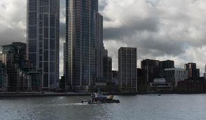 Preview wallpaper skyscrapers, buildings, city, sea, ship, clouds