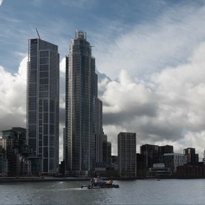 Preview wallpaper skyscrapers, buildings, city, sea, ship, clouds