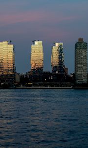 Preview wallpaper skyscrapers, buildings, city, water, glare