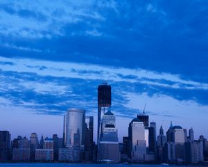 Preview wallpaper skyscrapers, buildings, city, sky, blue, evening