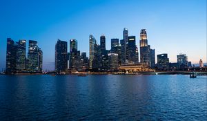 Preview wallpaper skyscrapers, buildings, lights, twilight, sea