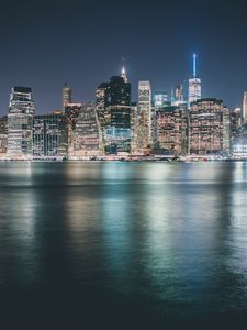 Preview wallpaper skyscrapers, buildings, lights, glow, sea, city, night