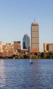 Preview wallpaper skyscrapers, buildings, sail, boat, river, city