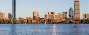 Preview wallpaper skyscrapers, buildings, sail, boat, river, city