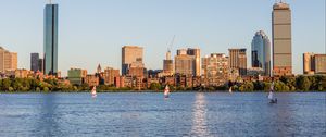 Preview wallpaper skyscrapers, buildings, sail, boat, river, city