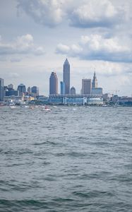 Preview wallpaper skyscrapers, buildings, sea, water, city, clouds