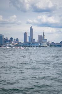 Preview wallpaper skyscrapers, buildings, sea, water, city, clouds