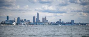 Preview wallpaper skyscrapers, buildings, sea, water, city, clouds