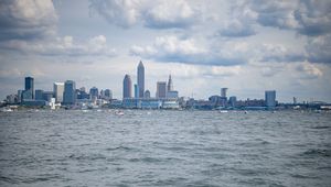 Preview wallpaper skyscrapers, buildings, sea, water, city, clouds