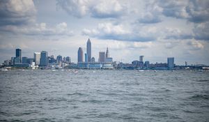 Preview wallpaper skyscrapers, buildings, sea, water, city, clouds