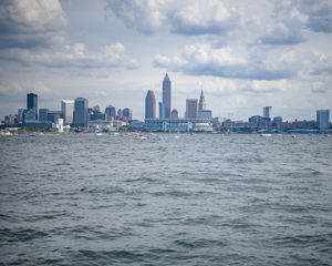 Preview wallpaper skyscrapers, buildings, sea, water, city, clouds