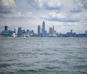 Preview wallpaper skyscrapers, buildings, sea, water, city, clouds