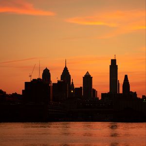 Preview wallpaper skyscrapers, buildings, silhouette, sunset, sea