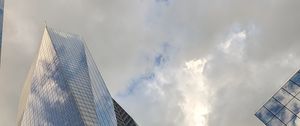 Preview wallpaper skyscrapers, buildings, sky, clouds, glass, reflection