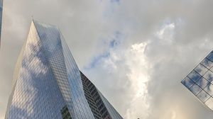 Preview wallpaper skyscrapers, buildings, sky, clouds, glass, reflection