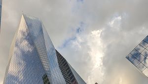 Preview wallpaper skyscrapers, buildings, sky, clouds, glass, reflection