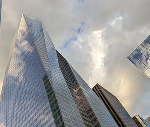 Preview wallpaper skyscrapers, buildings, sky, clouds, glass, reflection