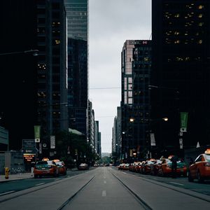 Preview wallpaper skyscrapers, city, road, cars