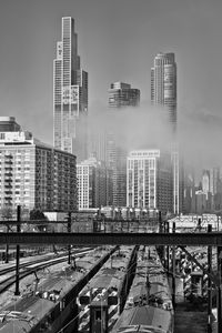 Preview wallpaper skyscrapers, fog, bridge, city, black and white