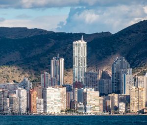 Preview wallpaper skyscrapers, houses, buildings, city, mountains