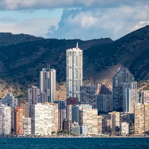 Preview wallpaper skyscrapers, houses, buildings, city, mountains