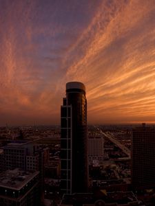 Preview wallpaper skyscrapers, houses, streets, traffic, metropolis, sky, clouds, dawn