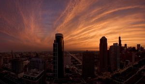 Preview wallpaper skyscrapers, houses, streets, traffic, metropolis, sky, clouds, dawn