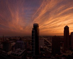 Preview wallpaper skyscrapers, houses, streets, traffic, metropolis, sky, clouds, dawn