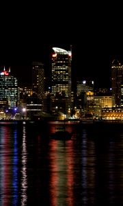 Preview wallpaper skyscrapers, lights, night, sea, boat, city