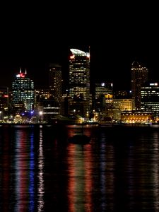 Preview wallpaper skyscrapers, lights, night, sea, boat, city