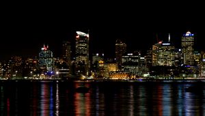 Preview wallpaper skyscrapers, lights, night, sea, boat, city