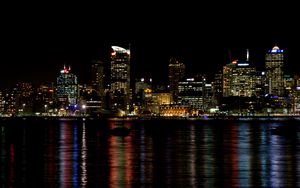 Preview wallpaper skyscrapers, lights, night, sea, boat, city