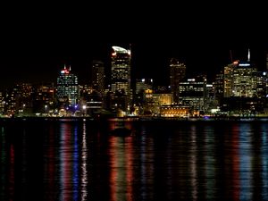 Preview wallpaper skyscrapers, lights, night, sea, boat, city