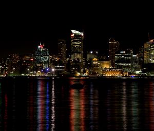 Preview wallpaper skyscrapers, lights, night, sea, boat, city