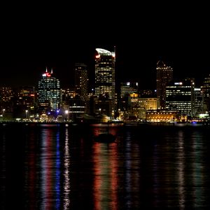 Preview wallpaper skyscrapers, lights, night, sea, boat, city