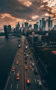 Preview wallpaper skyscrapers, road, evening