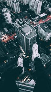 Preview wallpaper skyscrapers, roof, legs, shoes