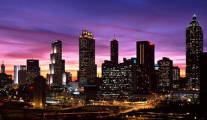 Preview wallpaper skyscrapers, sky, night, lights, buildings, panorama