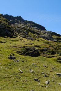 Preview wallpaper slope, hill, stones, landscape, nature, grass