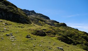 Preview wallpaper slope, hill, stones, landscape, nature, grass