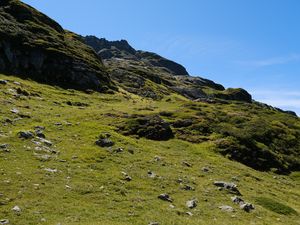 Preview wallpaper slope, hill, stones, landscape, nature, grass