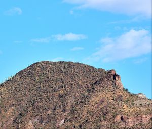 Preview wallpaper slope, mountain, rocks, bushes, sky