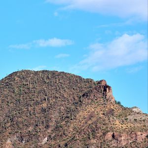 Preview wallpaper slope, mountain, rocks, bushes, sky