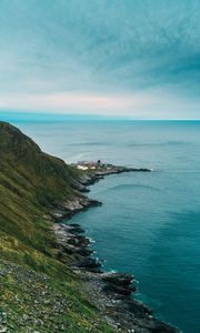 Preview wallpaper slope, rocks, sea, buildings, horizon