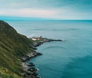 Preview wallpaper slope, rocks, sea, buildings, horizon