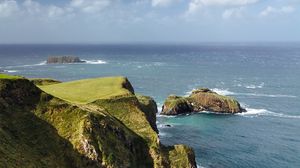 Preview wallpaper slope, rocks, sea, surf, horizon