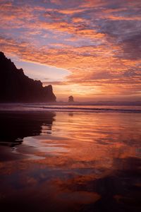 Preview wallpaper slope, rocks, sunset, sea, clouds, reflection