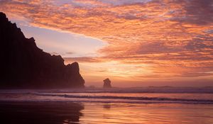 Preview wallpaper slope, rocks, sunset, sea, clouds, reflection