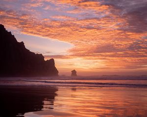 Preview wallpaper slope, rocks, sunset, sea, clouds, reflection